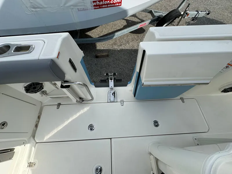 Slide: The Image of 2025 Boston Whaler 280 Outrage boat deck with storage compartments and seating. - 14