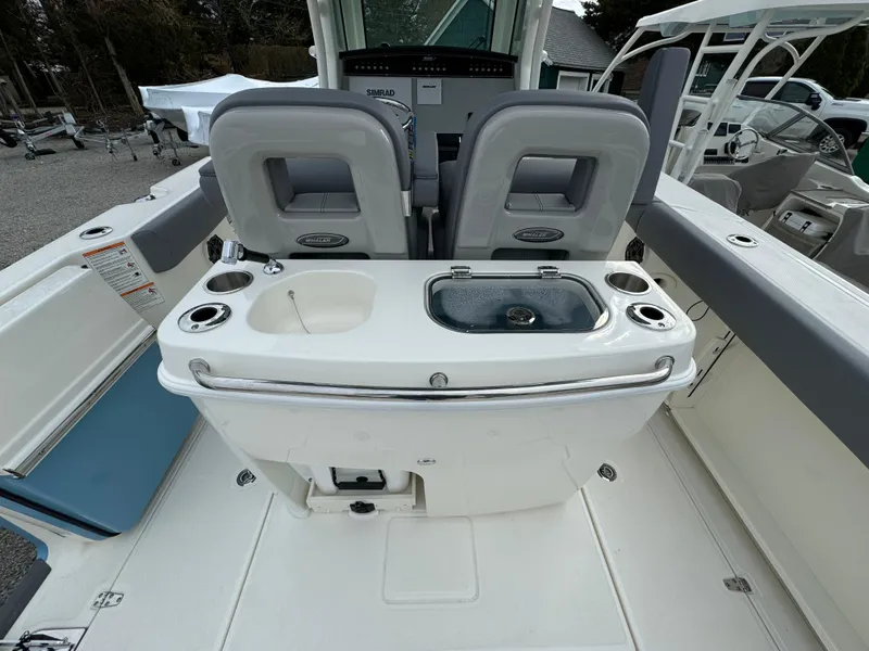Slide: The Image of 2025 Boston Whaler 280 Outrage boat interior with seating and fishing station. - 16