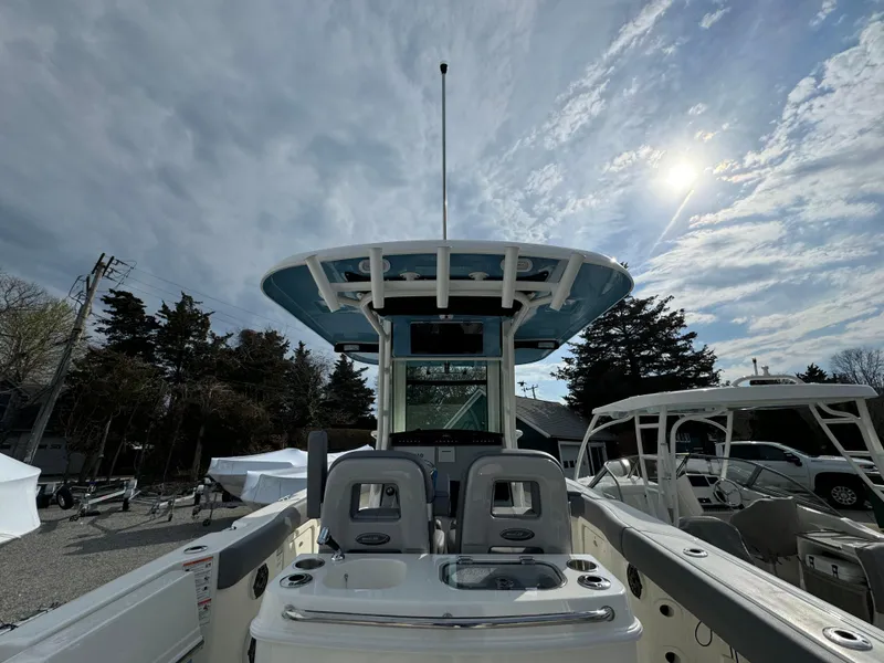 Slide: The Image of 2025 Boston Whaler 280 Outrage boat interior under cloudy sky with sun. - 18