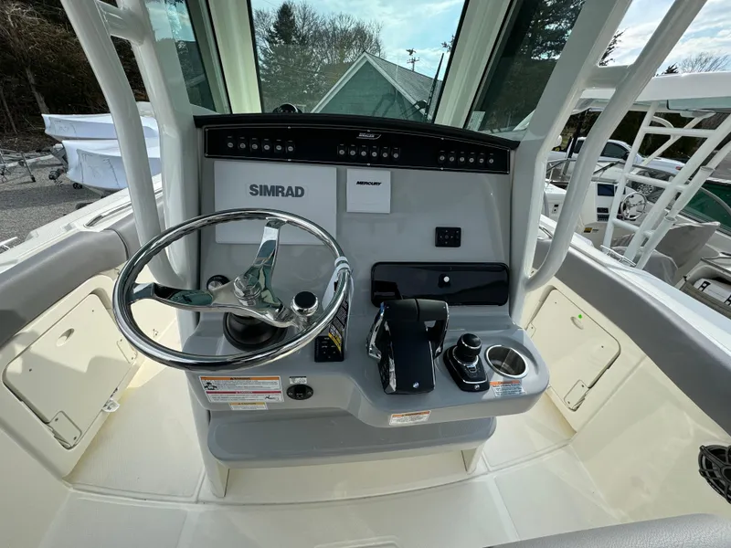 Slide: The Image of 2025 Boston Whaler 280 Outrage helm with Simrad electronics and modern controls. - 21