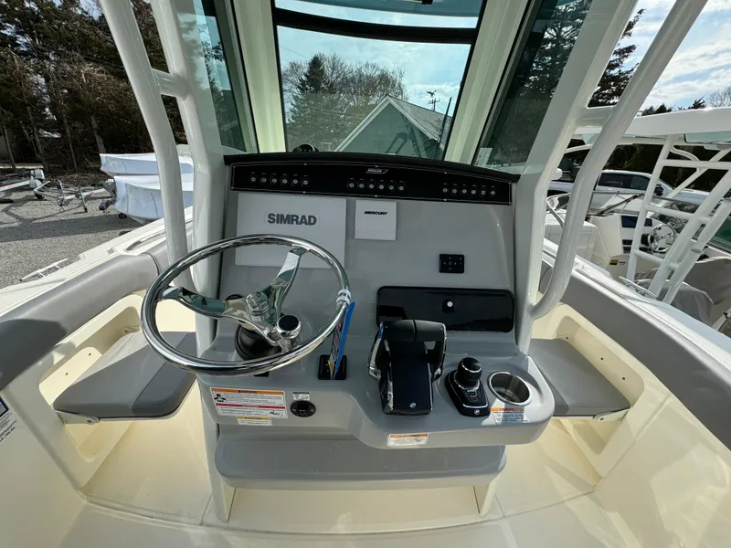 Slide: The Image of 2025 Boston Whaler 280 Outrage helm with Simrad electronics and modern controls. - 22