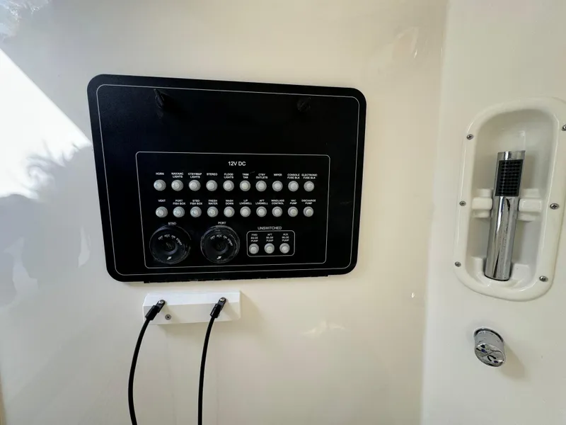 Slide: The Image of Control panel of 2025 Boston Whaler 280 Outrage boat, featuring various switches and dials. - 26
