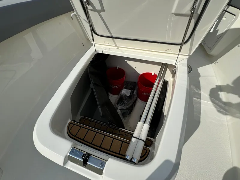 Slide: The Image of Storage compartment of 2025 Boston Whaler 280 Outrage with equipment and accessories. - 28