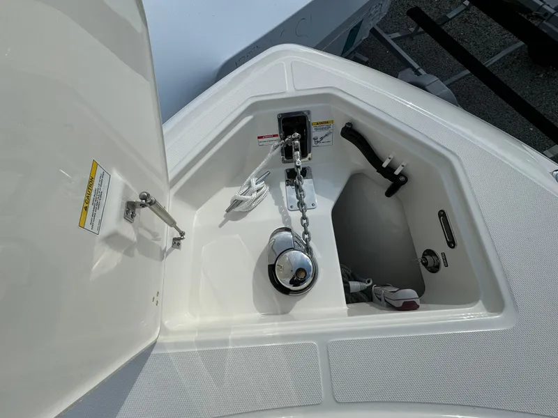 Slide: The Image of 2025 Boston Whaler 280 Outrage anchor compartment with chain and storage. - 36