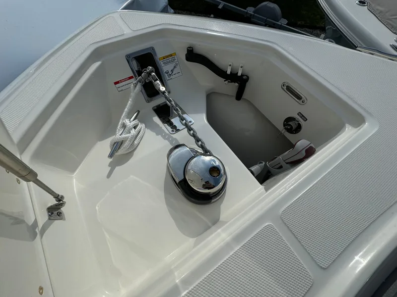 Slide: The Image of Anchor compartment of 2025 Boston Whaler 280 Outrage, featuring rope and winch system. - 37