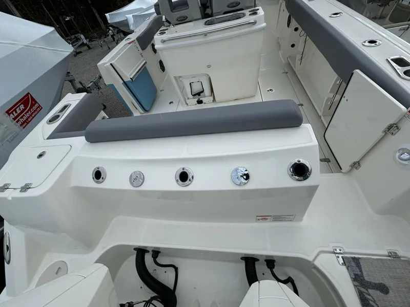 Slide: The Image of 2025 Boston Whaler 280 Outrage boat interior with seating and storage compartments. - 6