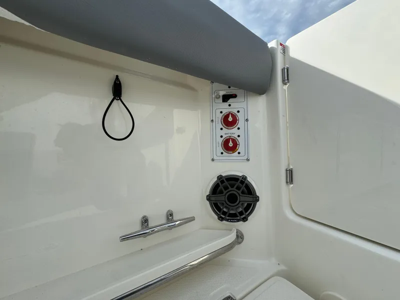 Slide: The Image of 2025 Boston Whaler 280 Outrage boat interior with control panel and speaker. - 7