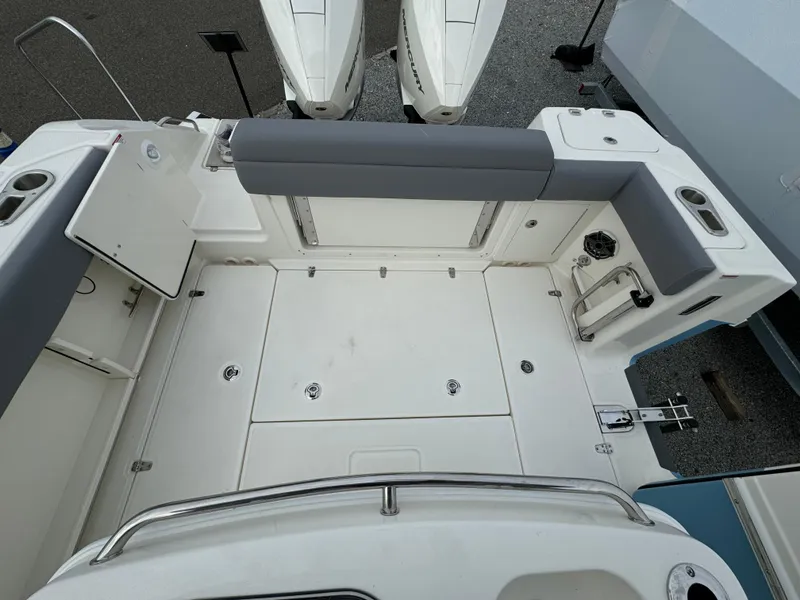 Slide: The Image of 2025 Boston Whaler 280 Outrage boat deck with seating and storage compartments. - 9