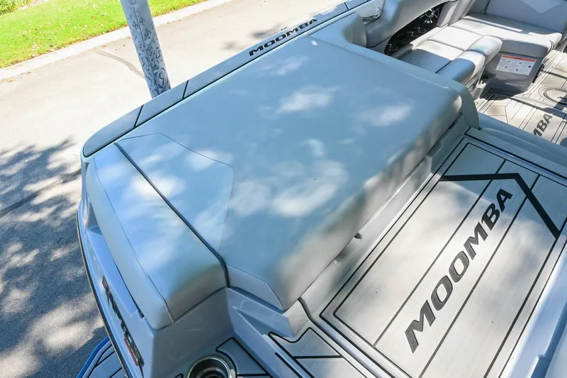 Slide: The Image of 2021 Moomba Kaiyen boat interior with cushioned seating and branded flooring. - 12