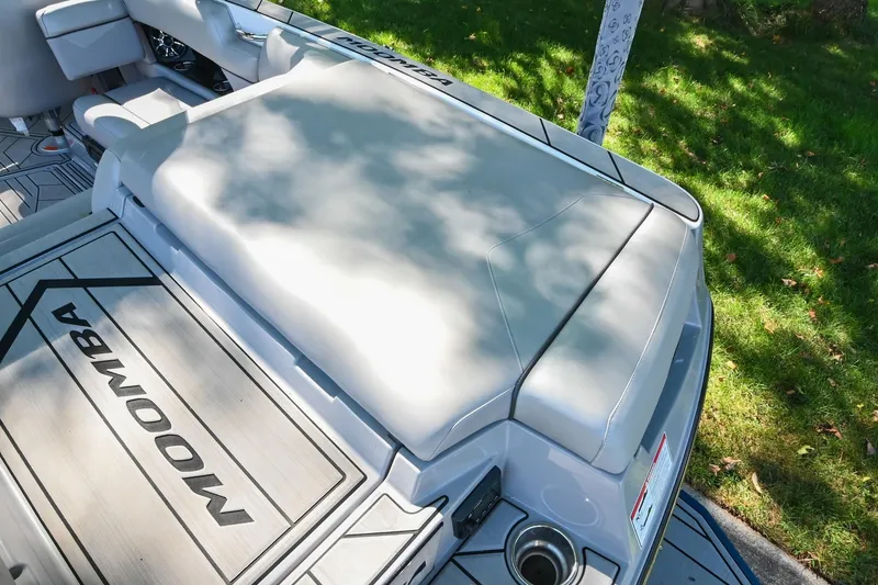 Slide: The Image of 2021 Moomba Kaiyen boat interior with cushioned seating and branded flooring. - 13