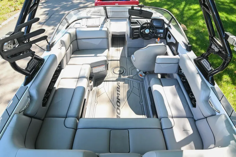 Slide: The Image of 2021 Moomba Kaiyen boat interior with spacious seating and modern dashboard. - 15