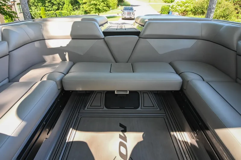 Slide: The Image of 2021 Moomba Kaiyen boat interior with gray seating and spacious layout. - 19