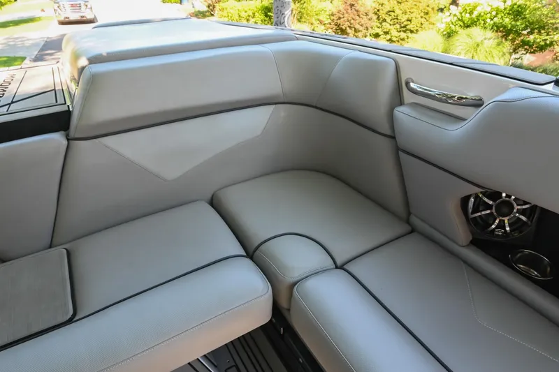 Slide: The Image of 2021 Moomba Kaiyen boat interior with gray seating and speaker detail. - 20