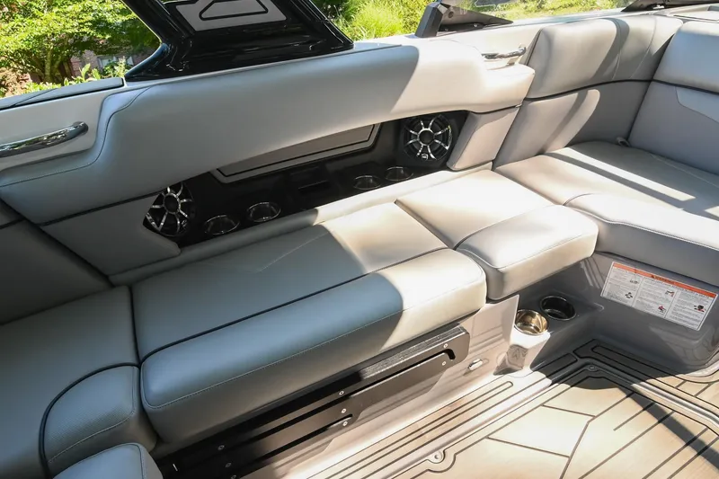 Slide: The Image of 2021 Moomba Kaiyen boat interior with gray seating and cup holders. - 22