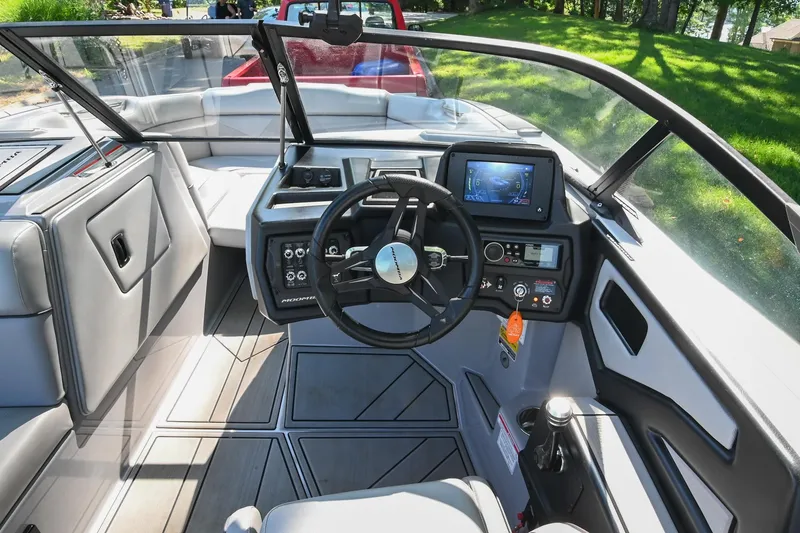 Slide: The Image of 2021 Moomba Kaiyen boat interior with steering wheel and dashboard controls. - 26
