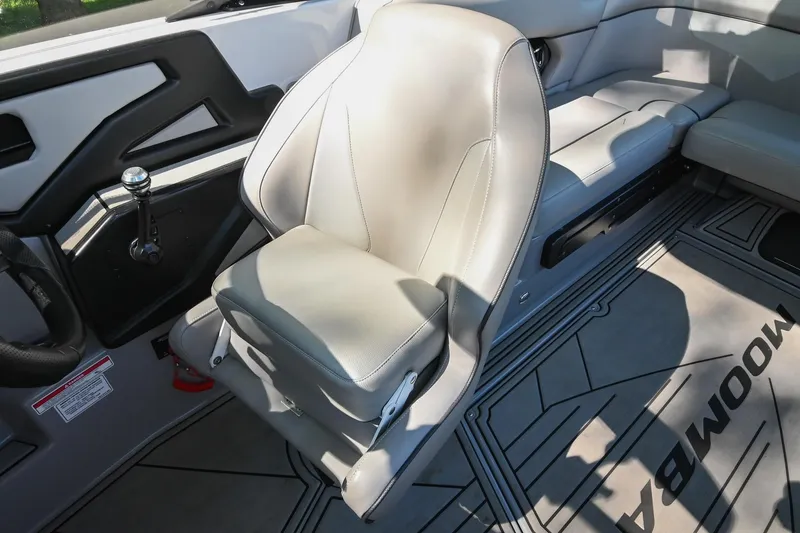 Slide: The Image of 2021 Moomba Kaiyen interior with gray captain's chair and sleek dashboard design. - 30
