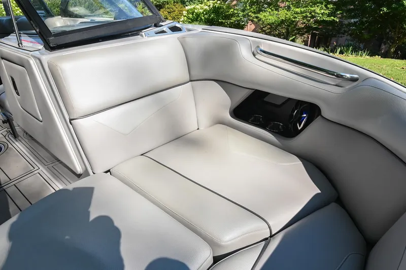 Slide: The Image of 2021 Moomba Kaiyen boat interior with gray seating and cup holders. - 33