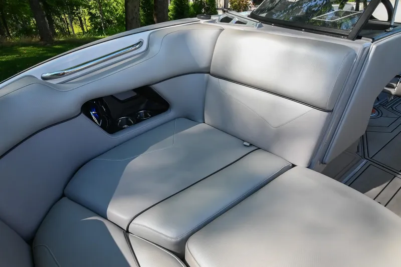Slide: The Image of 2021 Moomba Kaiyen boat interior with gray seating and cup holders. - 34