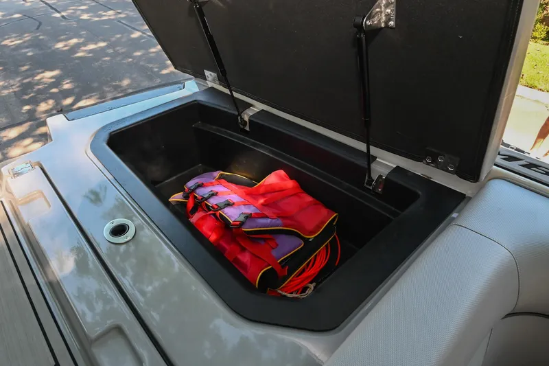 Slide: The Image of Open storage compartment in 2021 Moomba Kaiyen boat with red life jacket inside. - 35