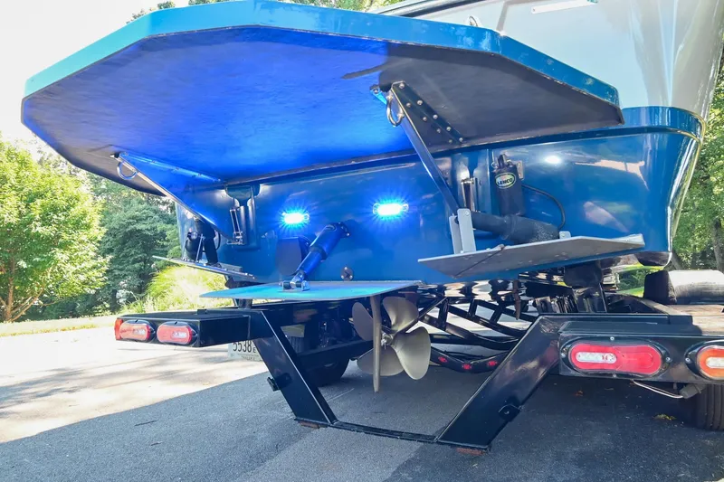 Slide: The Image of 2021 Moomba Kaiyen boat rear view with blue lights and trailer. - 38