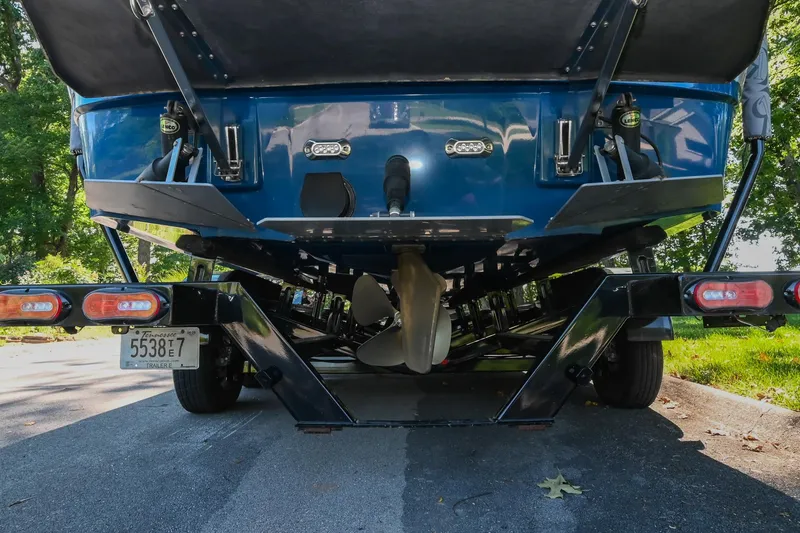 Slide: The Image of 2021 Moomba Kaiyen boat on trailer, rear view showing propeller and license plate. - 39