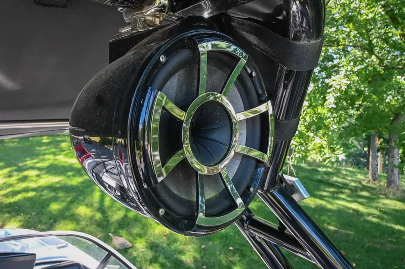 Slide: The Image of 2021 Moomba Kaiyen boat speaker with chrome accents, set against a lush green background. - 41