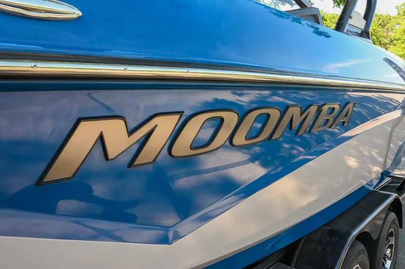 Slide: The Image of 2021 Moomba Kaiyen boat with blue and white exterior detailing. - 7