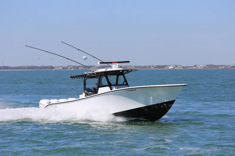 Slide: The Image of 2018 Yellowfin 39 boat cruising on open water under clear blue sky. - 10