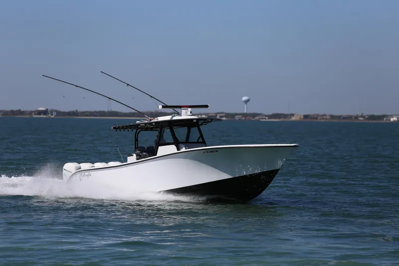 Slide: The Image of 2018 Yellowfin 39 boat cruising on open water under clear skies. - 11