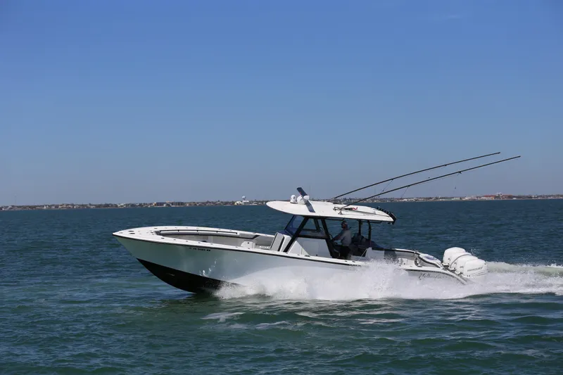 Slide: The Image of 2018 Yellowfin 39 boat cruising on open water under clear blue sky. - 12