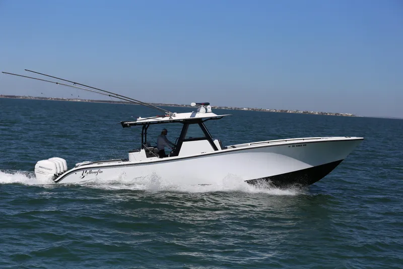 Slide: The Image of 2018 Yellowfin 39 boat cruising on open water under clear blue sky. - 13