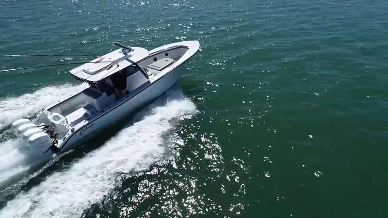 Slide: The Image of 2018 Yellowfin 39 boat cruising on open water, showcasing sleek design and powerful engines. - 14