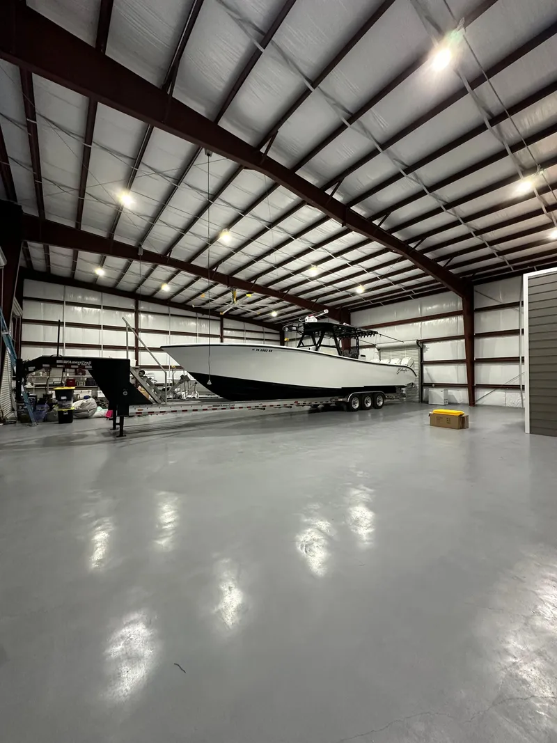 Slide: The Image of 2018 Yellowfin 39 boat inside a spacious, well-lit warehouse. - 17