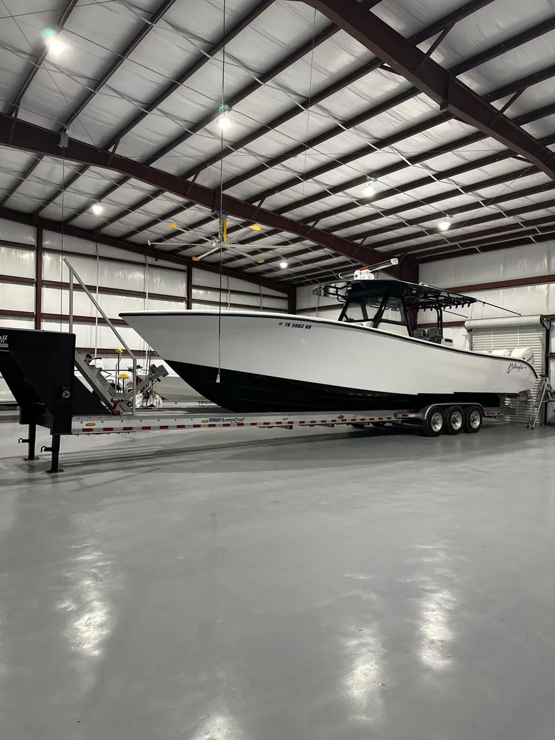 Slide: The Image of 2018 Yellowfin 39 boat on trailer inside a spacious warehouse. - 18