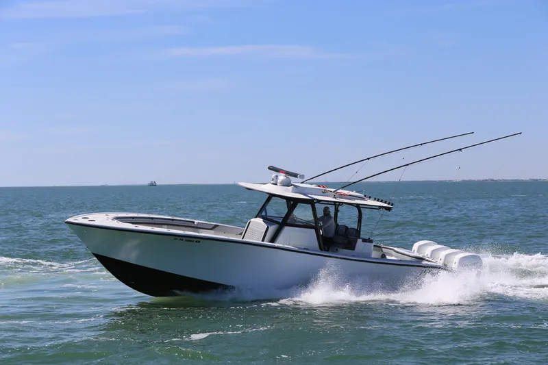 Slide: The Image of 2018 Yellowfin 39 boat cruising on open water, equipped with fishing rods. - 2