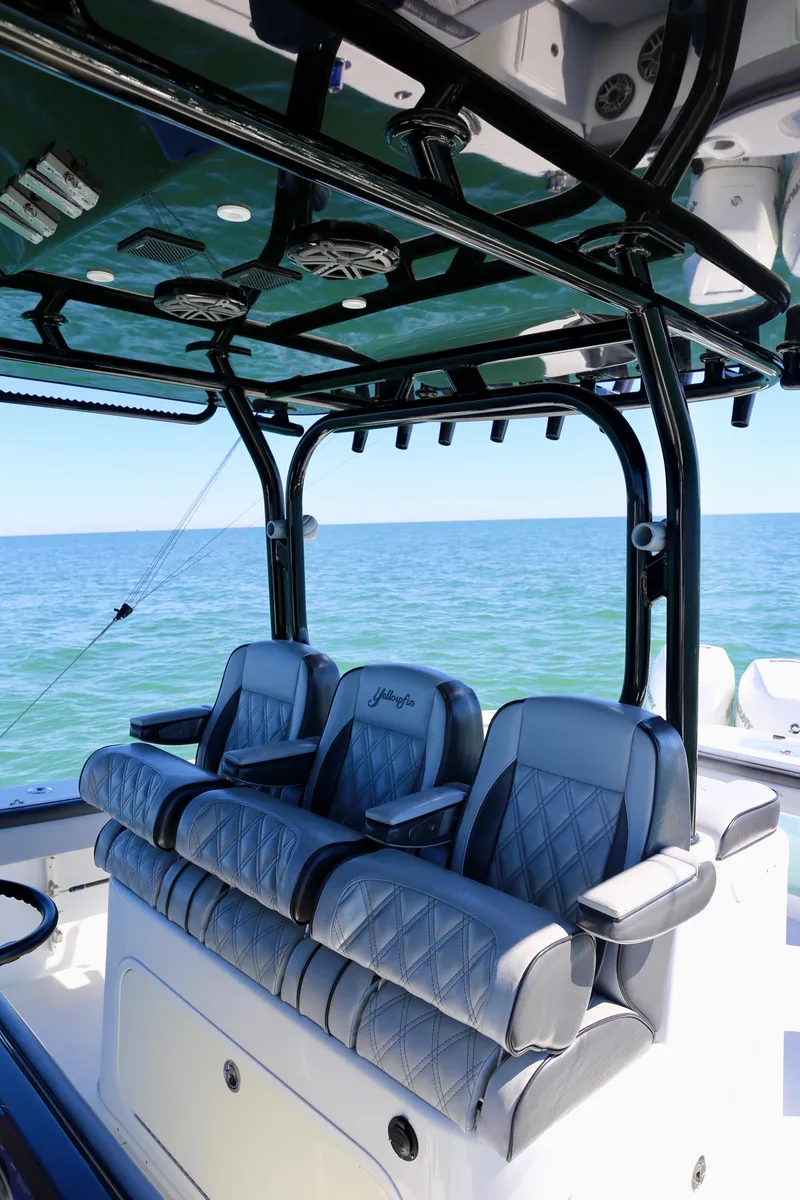 Slide: The Image of 2018 Yellowfin 39 boat interior with luxury seating and ocean backdrop. - 20