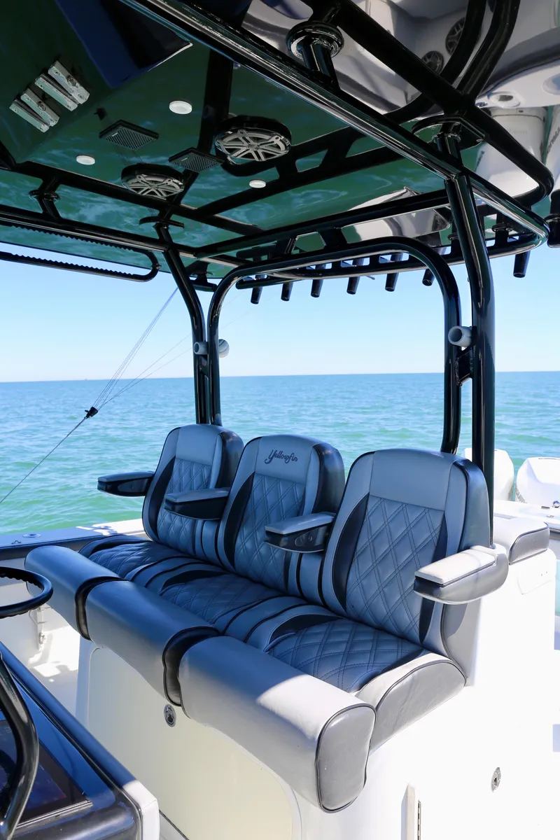 Slide: The Image of 2018 Yellowfin 39 boat interior with cushioned seating and ocean view. - 21