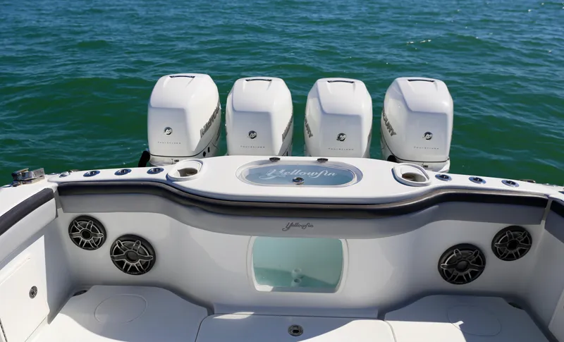 Slide: The Image of 2018 Yellowfin 39 boat with four powerful outboard engines on open water. - 24