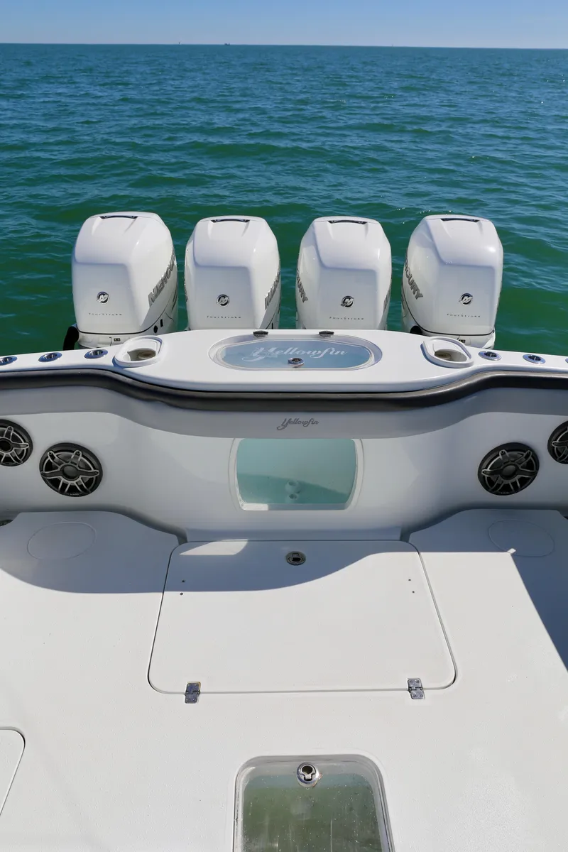 Slide: The Image of 2018 Yellowfin 39 boat with four outboard engines on open water. - 25