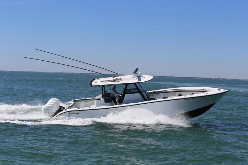 Slide: The Image of 2018 Yellowfin 39 boat cruising on open water under clear blue sky. - 3