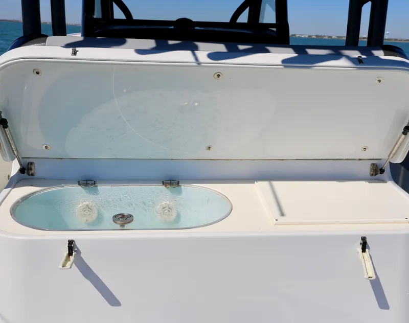 Slide: The Image of 2018 Yellowfin 39 boat livewell with open lid, showcasing water and interior features. - 31