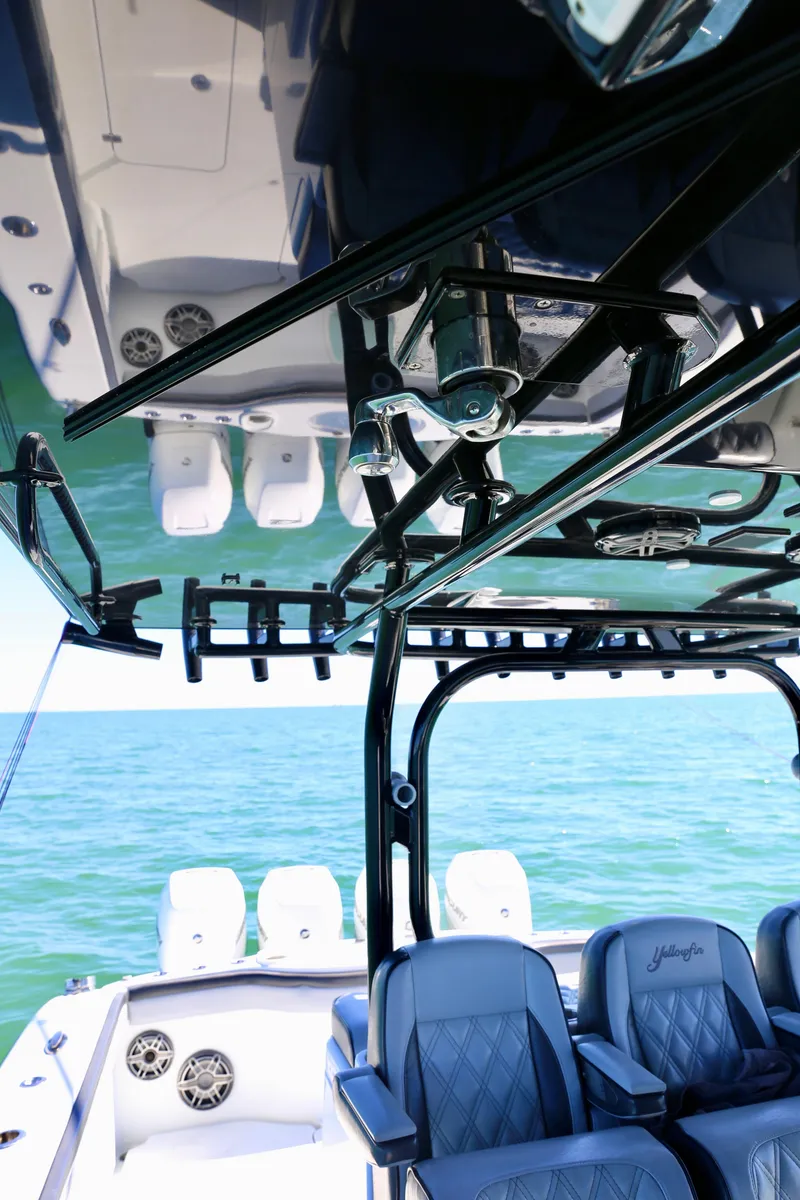 Slide: The Image of 2018 Yellowfin 39 boat interior with ocean view, featuring seating and equipment. - 32
