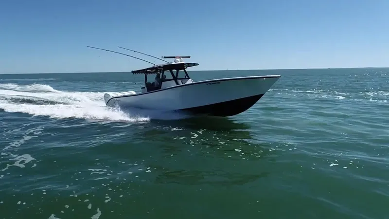 Slide: The Image of 2018 Yellowfin 39 boat cruising on open water under clear blue sky. - 6