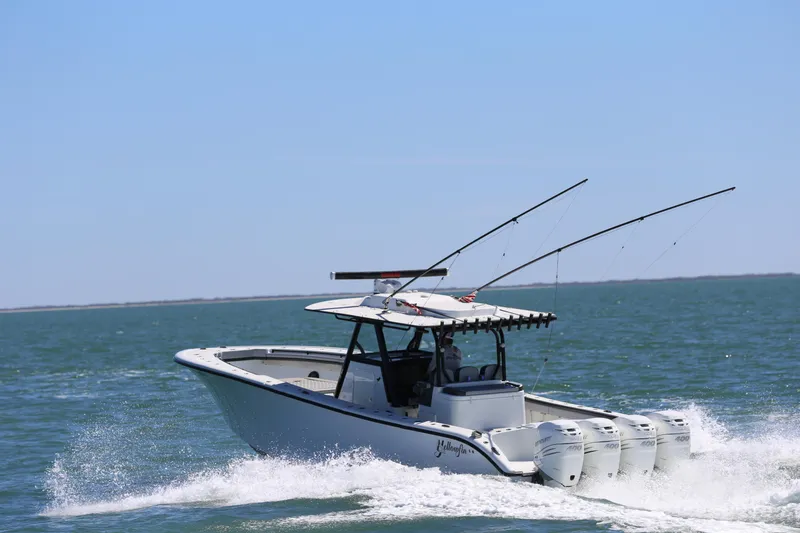 Slide: The Image of 2018 Yellowfin 39 boat cruising on open water with fishing rods. - 7