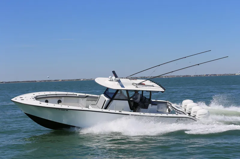 Slide: The Image of 2018 Yellowfin 39 boat cruising on open water, equipped with multiple outboard engines. - 8