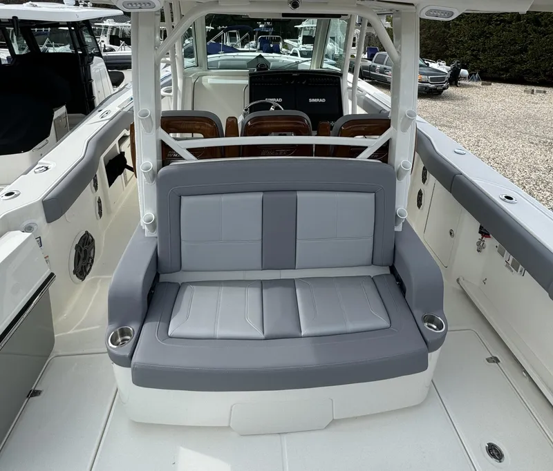 Slide: The Image of 2025 Boston Whaler 380 Outrage boat interior with gray seating and cup holders. - 10