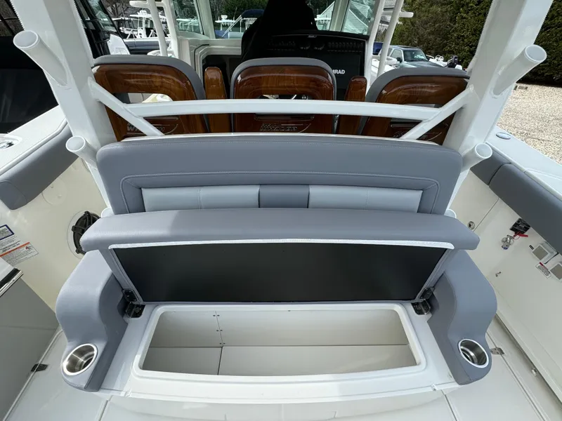 Slide: The Image of 2025 Boston Whaler 380 Outrage interior with seating and storage compartment. - 12