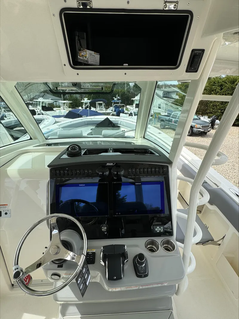Slide: The Image of 2025 Boston Whaler 380 Outrage helm with advanced navigation displays and controls. - 17