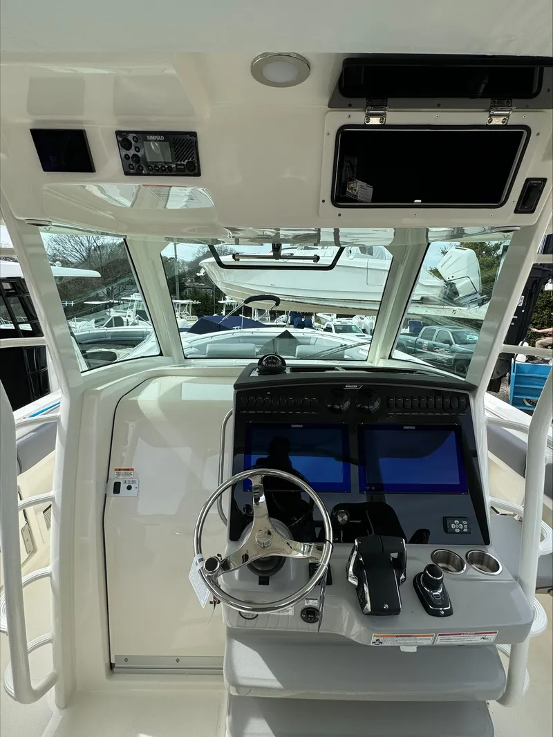 Slide: The Image of 2025 Boston Whaler 380 Outrage helm with advanced navigation and control systems. - 20