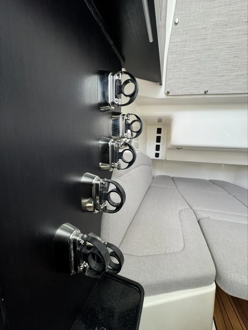 Slide: The Image of Interior of 2025 Boston Whaler 380 Outrage, featuring sleek rod holders and comfortable seating. - 24